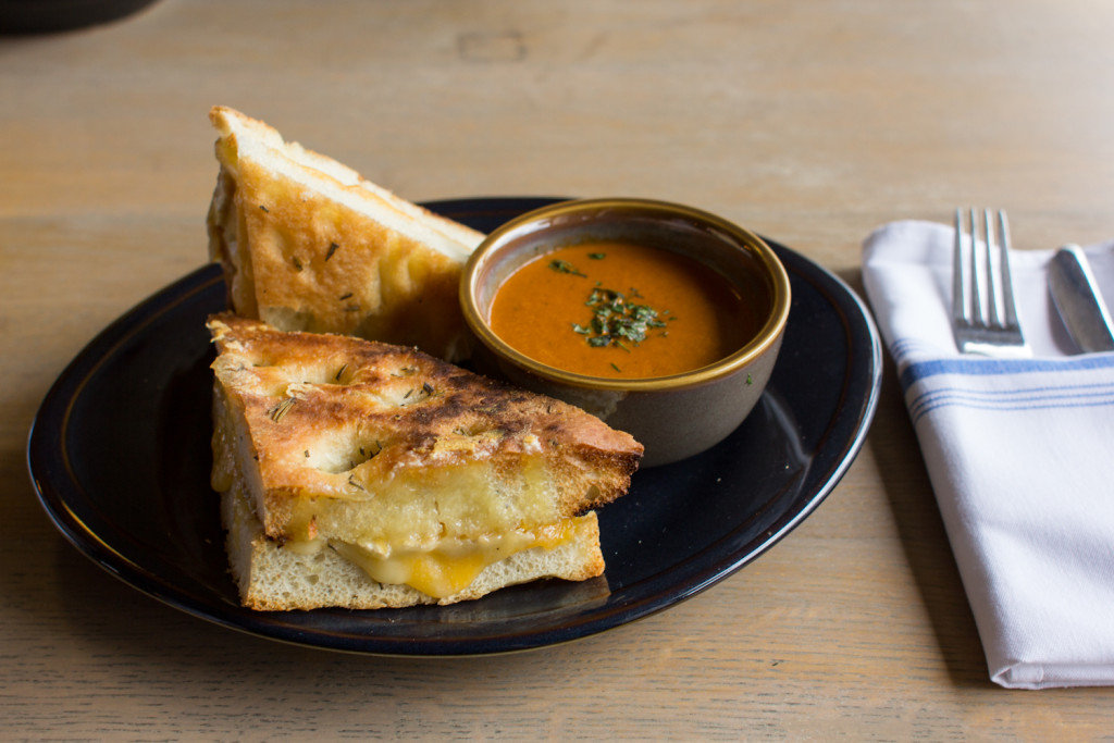 The crowd-pleasing grilled cheese comes on rosemary focaccia with cheddar, smoked gouda and brie as well as a cup of spicy tomato soup.
