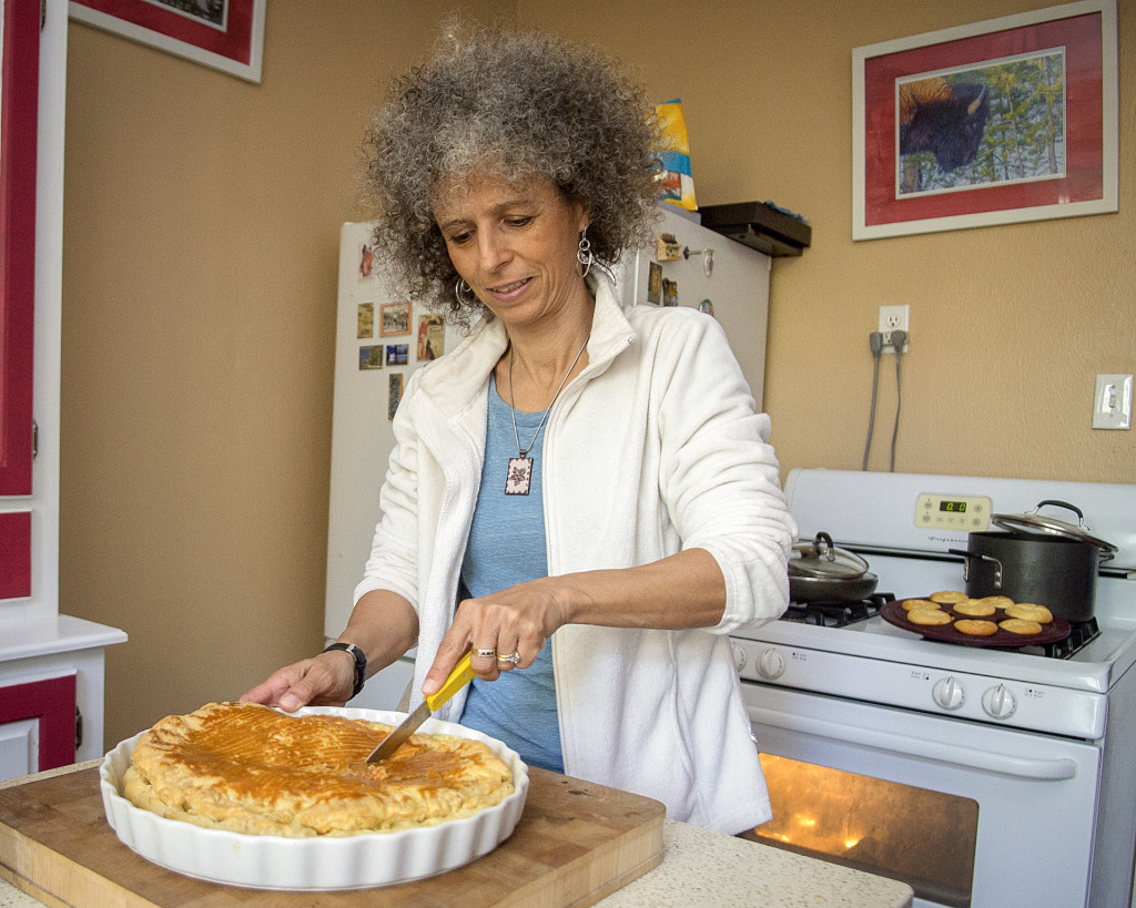 Babeth Schlagel cuts into an old-fashioned king cake, or galette des rois, in her kitchen.