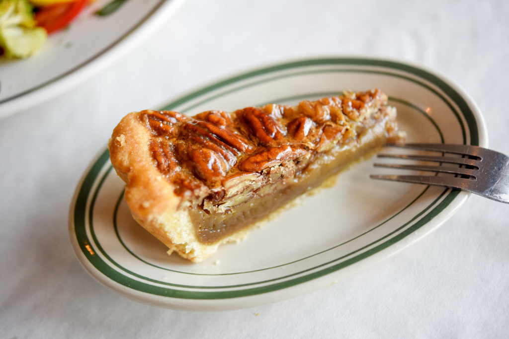 A traditional bourbon pecan pie with a flaky homemade crust.