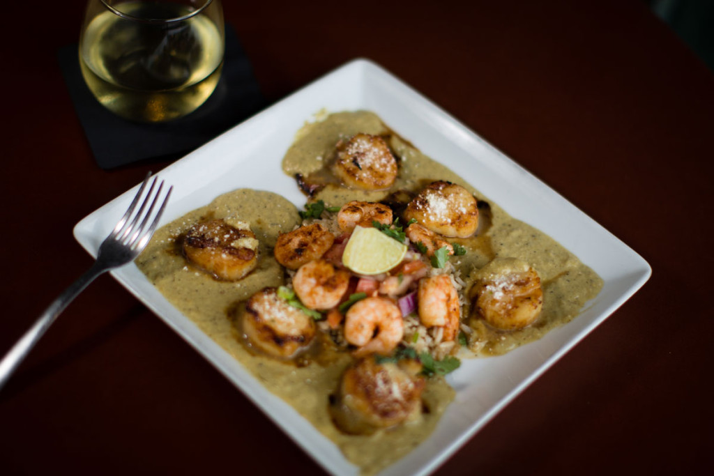 Seared diver scallops in white wine over brown rice, mole verde, grilled shrimp and avocado.