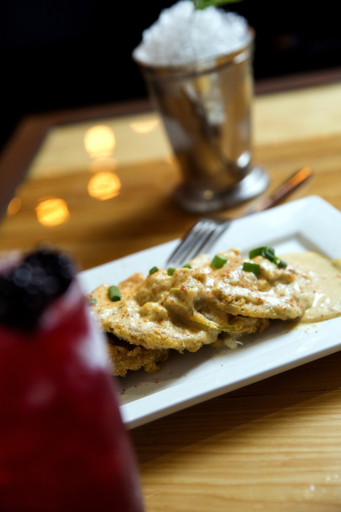  The Fried Green Tomatoes appetizer is topped with crabmeat and a spicy au gratin sauce.