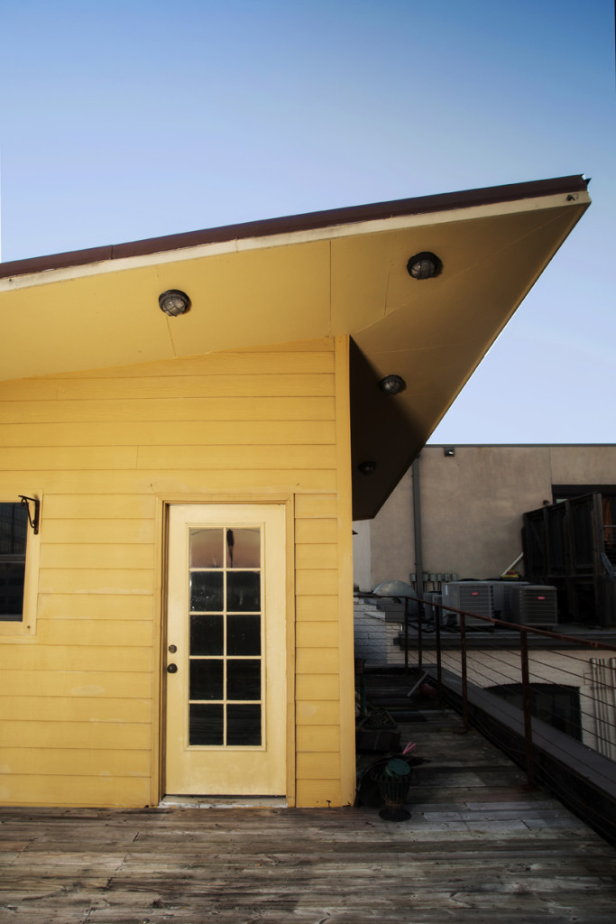 As seen from the rooftop balcony, the third floor of Hill’s apartment has a small, slanted-roof attic/loft space. Hill says he uses it occasionally to work out.