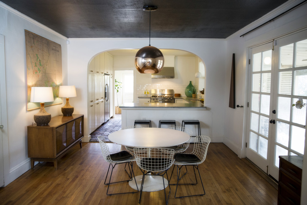 With the open floor plan, the Ellises can watch their kids playing in the living room while they cook. The dining table, found for Ellis by one of her friends, keeps with the home’s clean look, while the copper pendant light adds warmth.