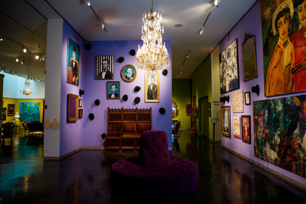 The exhibition space was made to reflect the design and character of Slonem’s own homes, with details such as antique chandeliers and pieces from his top hat collection.