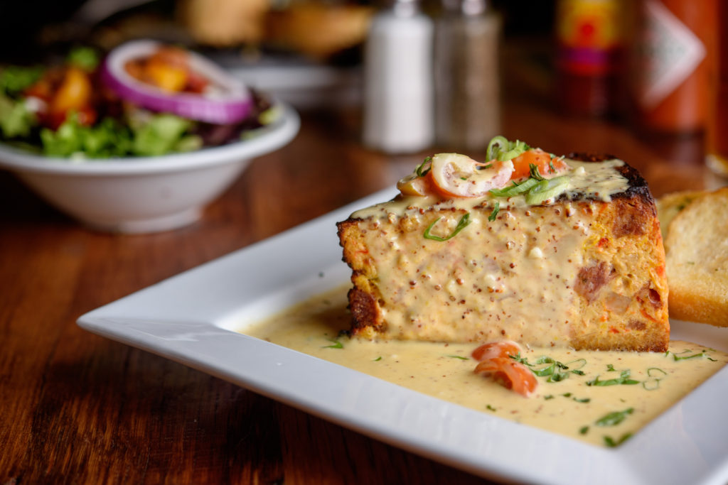 Drenched in a rich Creole mustard sauce, the Shrimp and Alligator Sausage Cheesecake is a unique signature appetizer.