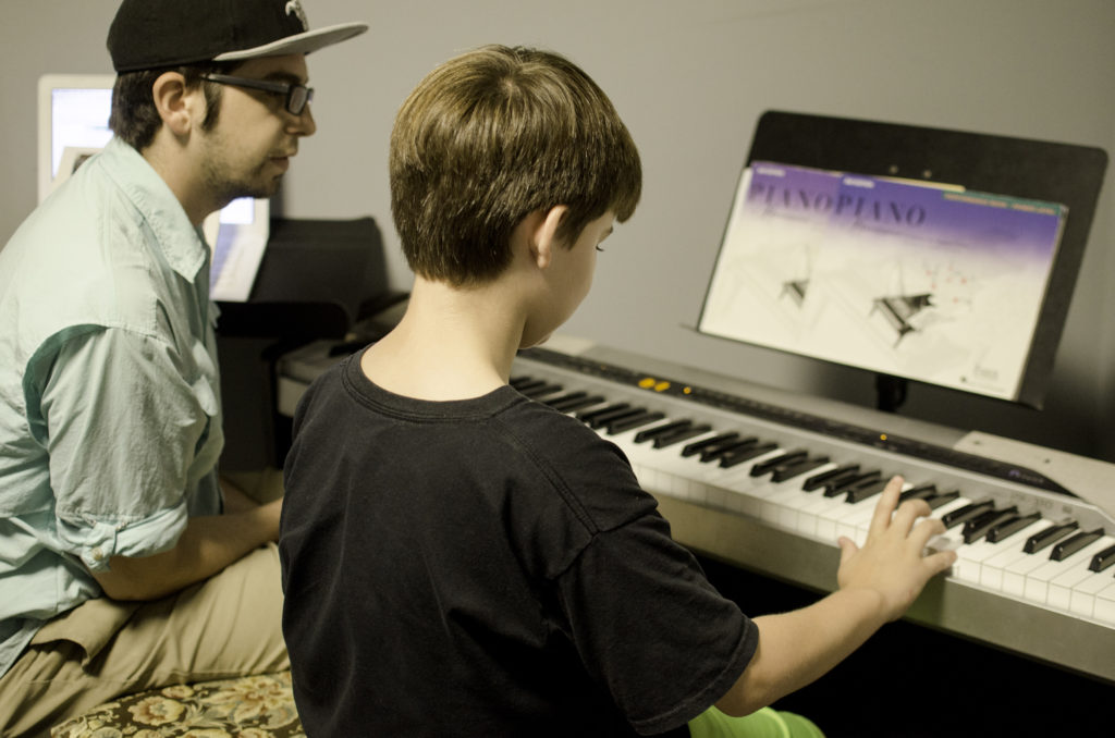 Music instructor John Mann works with a student during piano lessons at Baton Rouge Music Studios.