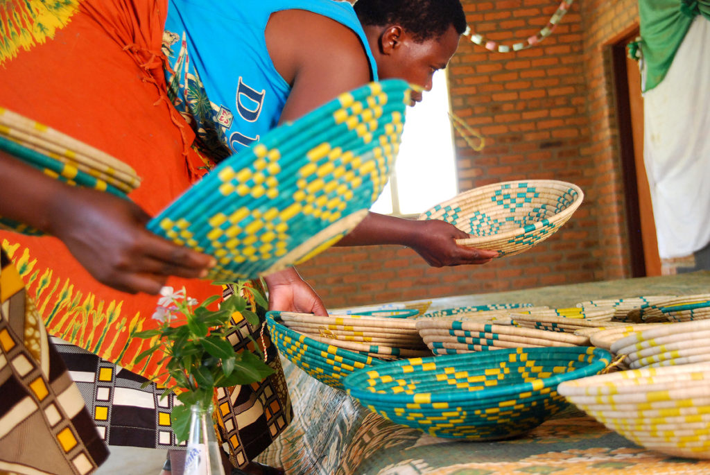 Last month, Hands Producing Hope launched its brightly colored basket collection made by the Rwandan women pictured here. Photo courtesy Hands Producing Hope