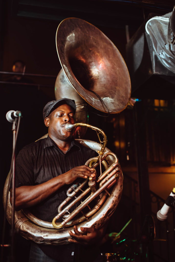 Michael Foster plays the sousaphone during an early July performance.