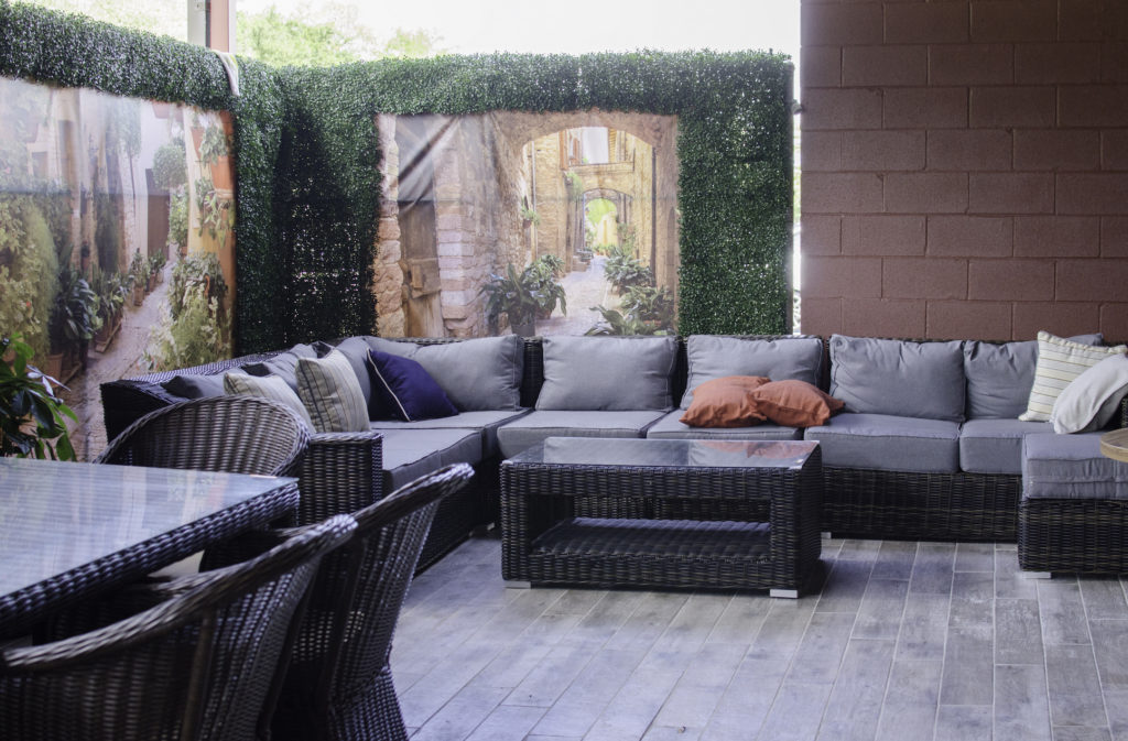 The attached patio is cooled by a large outdoor air conditioner and has several seating areas.