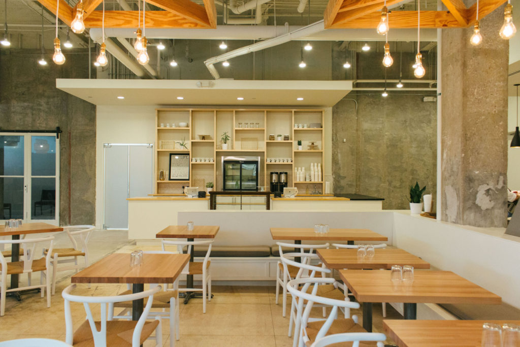 The main breakfast and lunch counter, where customers can find an antique display case of pastries and sweets.