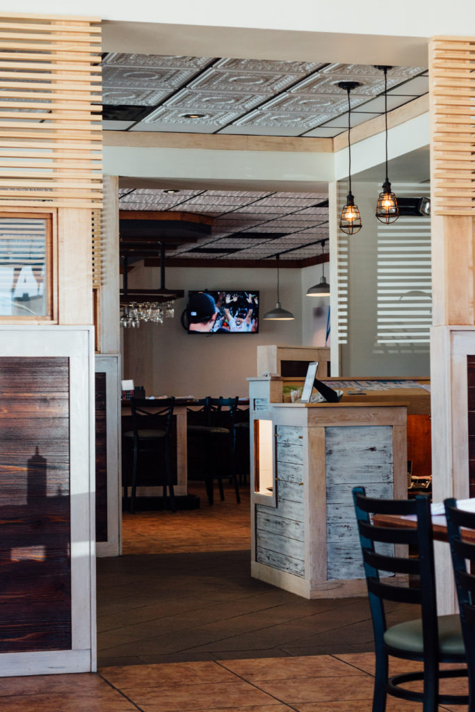 The restaurant's interior includes neutral colors, woods and a molded ceiling. 