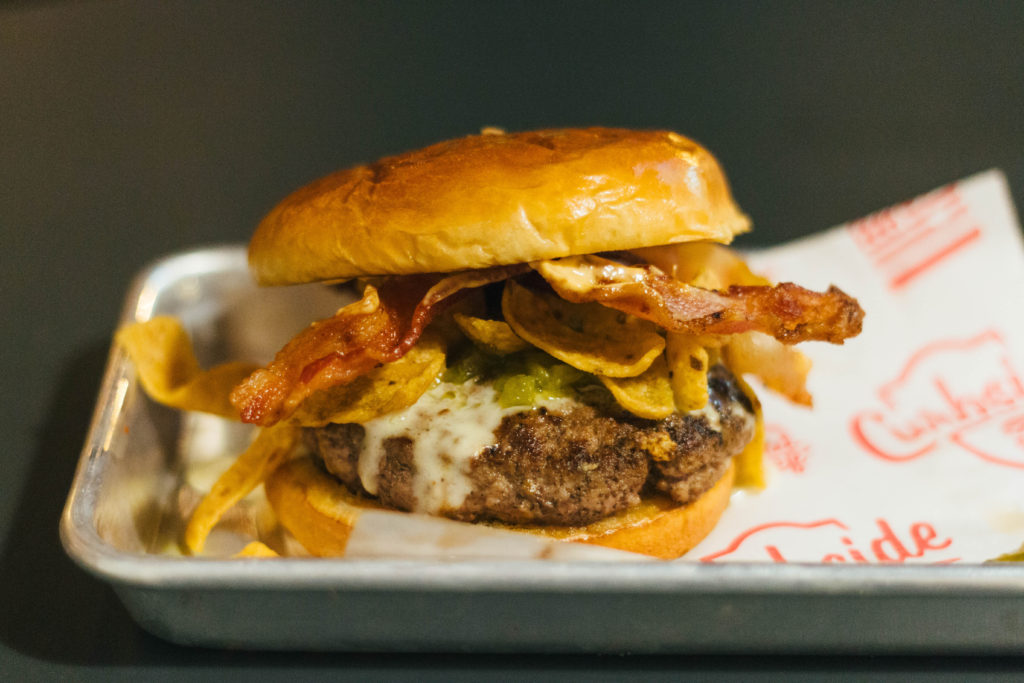 The GC2 burger with green chili relish, bacon, pepperjack fondue, Fritos and cholula mayo