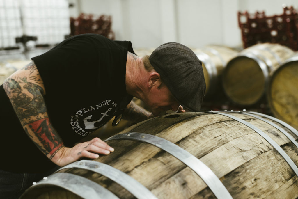 Head of distilling Jonny VerPlanck sniffs rum aging in one of Cane Land's barrels