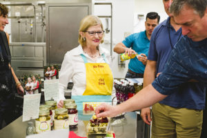 Gaye Spaht with Old Soul Pickles (front), Joseph Tucker with Hydra-Guard Recharge (back) serve samples to the guests